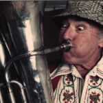 closeup of Dick Saunders playing an instrument