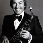 Dick Saunders with a Saxophone smiling